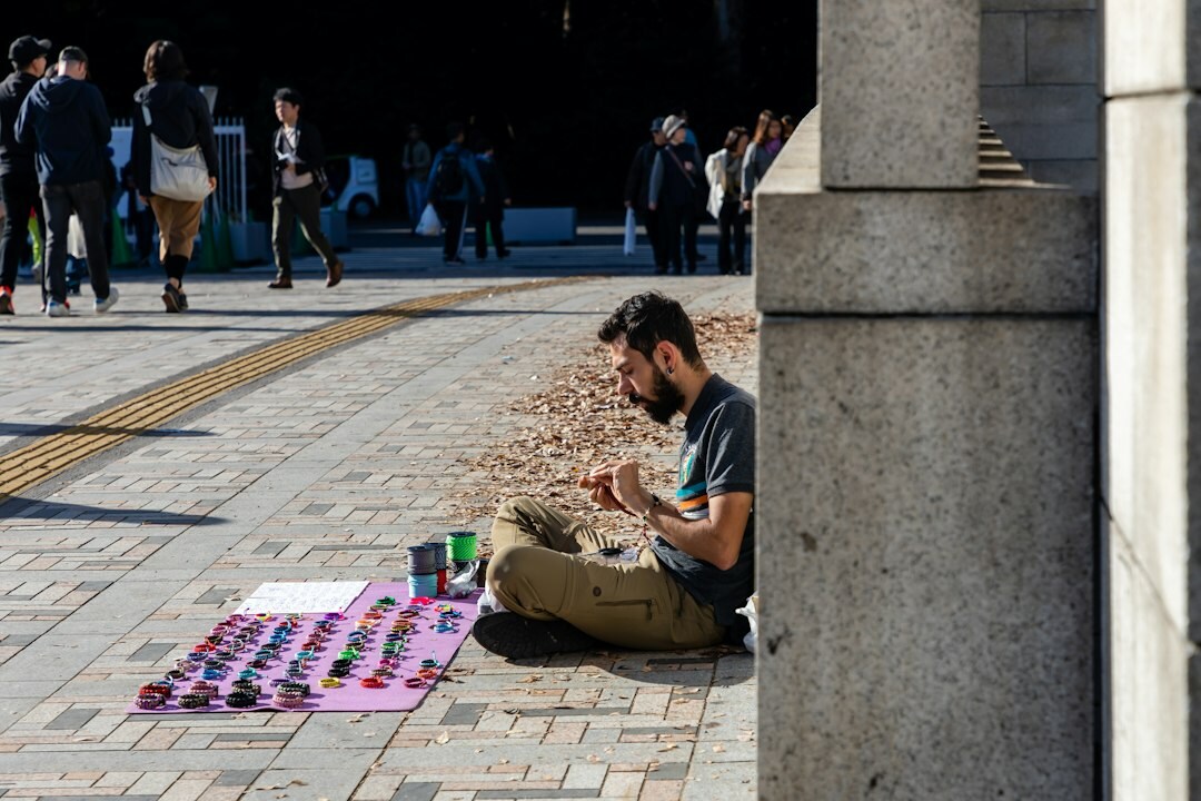 Person writing notes on a city street